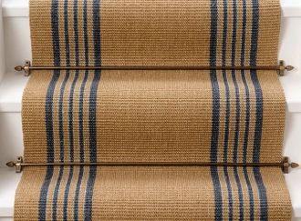 A striped sisal stair runner with brass rods on white stairs.