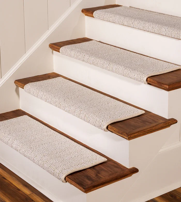 Each stair has a light beige, textured synthetic carpet tread covering the middle section.