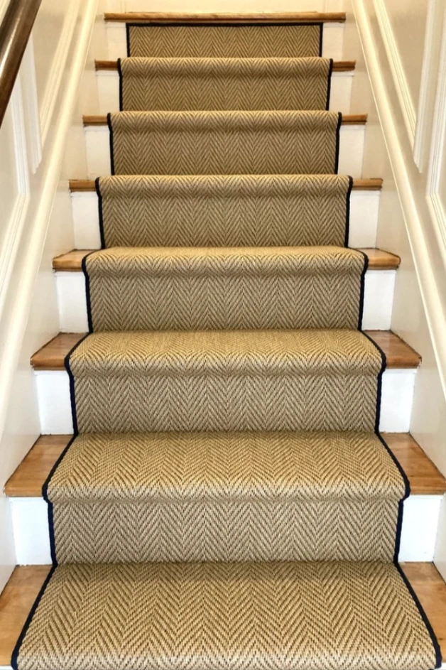 Gold-toned sisal herringbone carpet on stairs and landing.