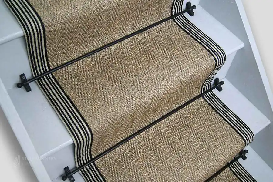 Herringbone sisal stair runner with a luxury black cotton border installed in a Dubai villa.