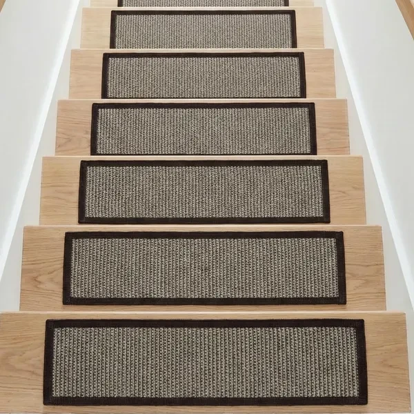 light-colored wooden staircase featuring rectangular sisal stair tread carpets.