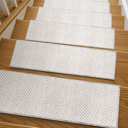 light grey and cream herringbone pattern with a finished, stitched border.