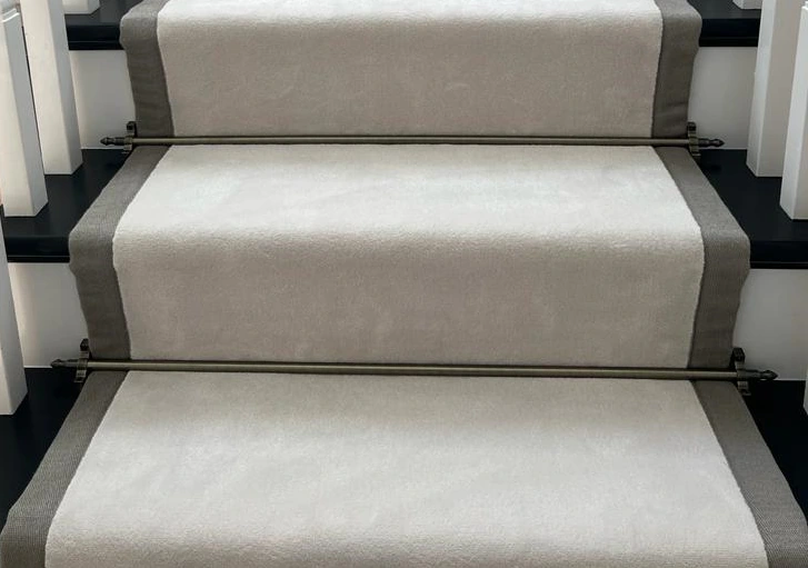 silk-blend stair runner in a soft cream color with a textured grey border.