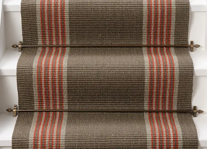 sisal stair runner with a vertical orange and cream striped border.