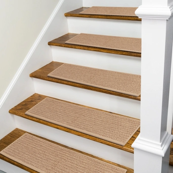 textured non-slip carpet treads centered on a wooden staircase with white risers and a white banister post.
