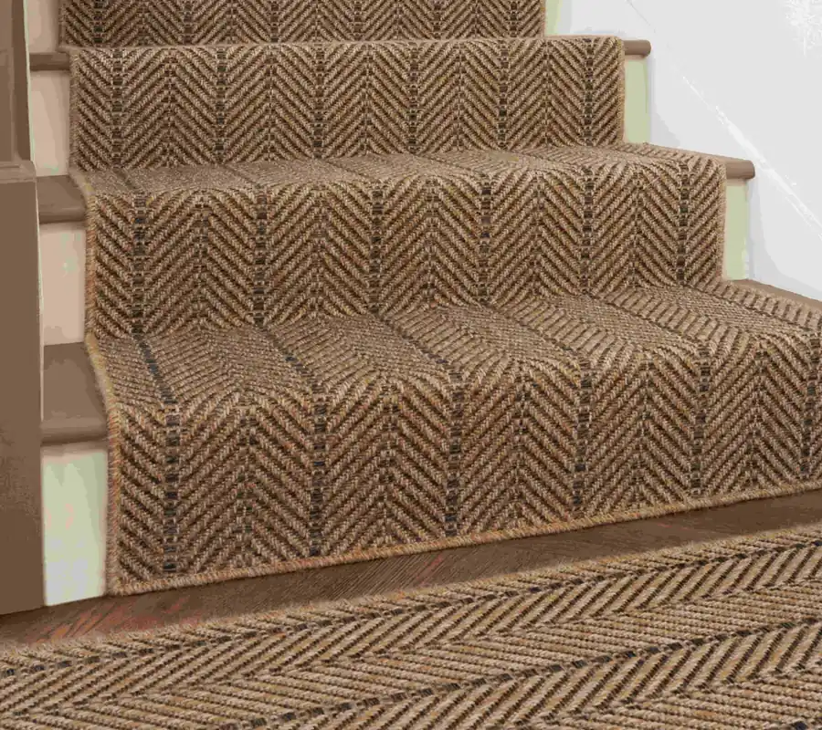 wooden stairs covered in a brown and tan chevron-patterned sisal runner.