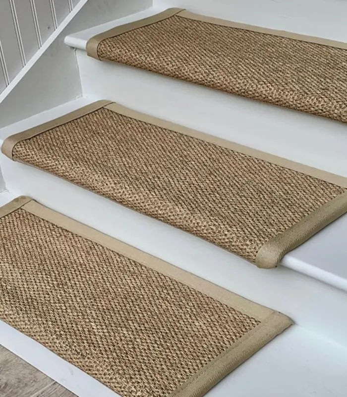 wooden stairs fitted with individual rectangular sisal stair treads.