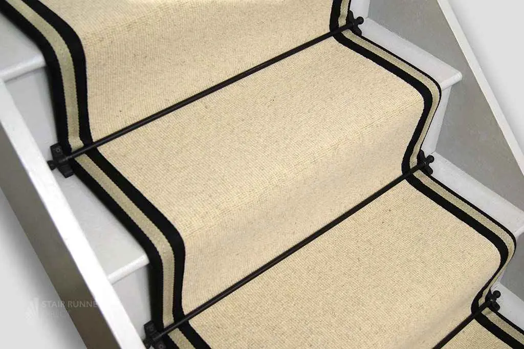 wool sisal-style stair runner on white painted stairs.