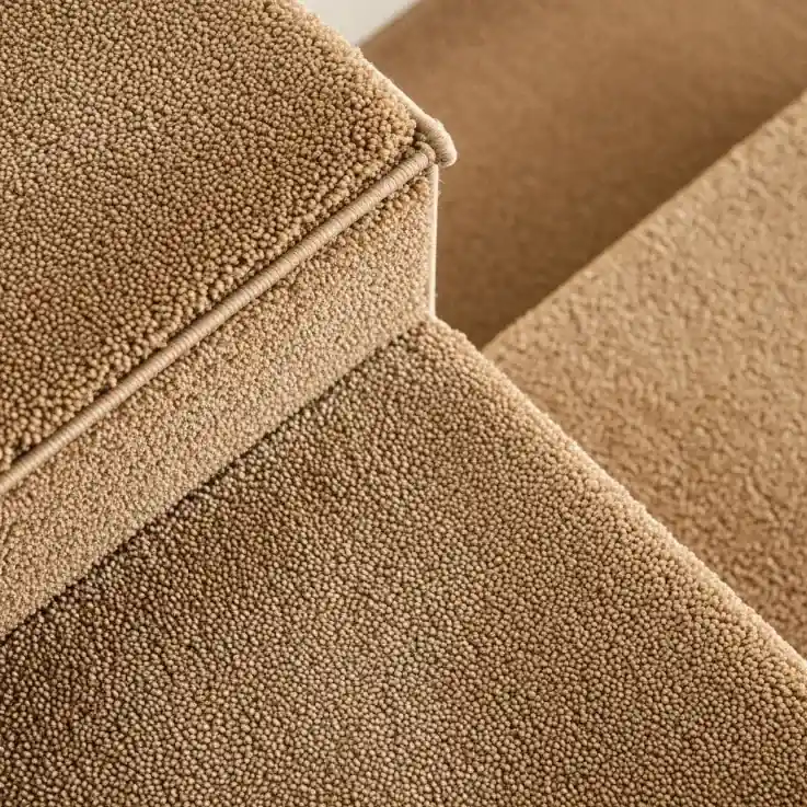 Beige carpet texture on staircase with loop pile finish