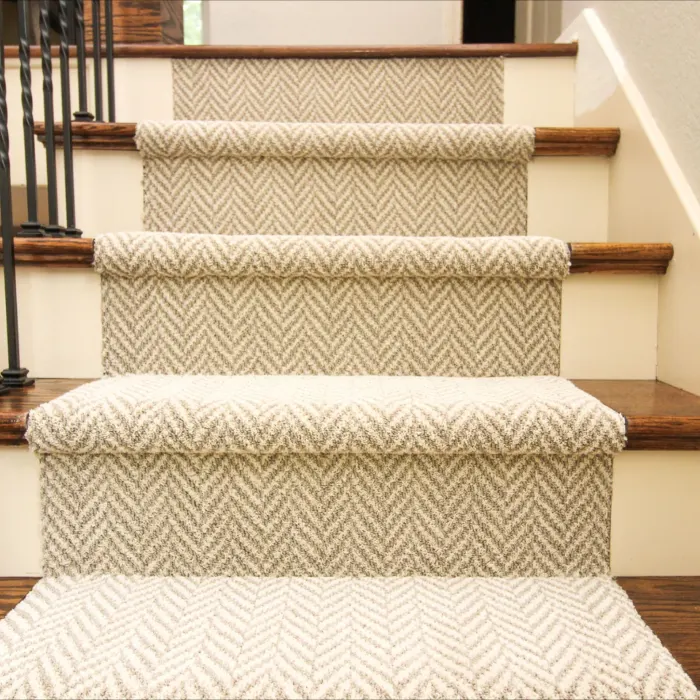 Anti-slip chevron pattern carpet runner securely fitted on hardwood steps for Anti Slip Stair Runner Dubai.