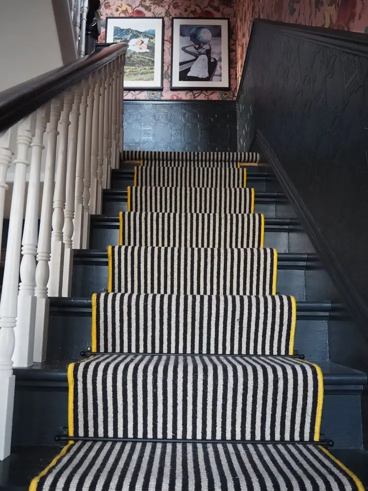 Black and cream striped stair carpet runner featuring vibrant yellow edge binding and black stair rods for Striped Stair Runners Dubai.