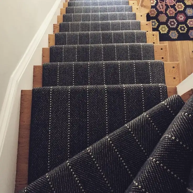 Dark grey pinstriped stair carpet runner fitted on wooden steps for Stair Carpet Runners Dubai.