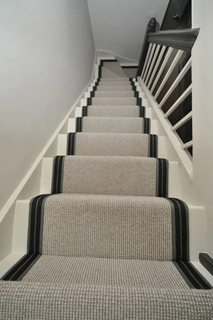 Durable wool-nylon blend stair runner with striped border trim installed on white painted stairs for Wool-Nylon Stair Runners Dubai.