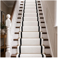 Elegant white wool stair runner with black borders on a classic staircase.