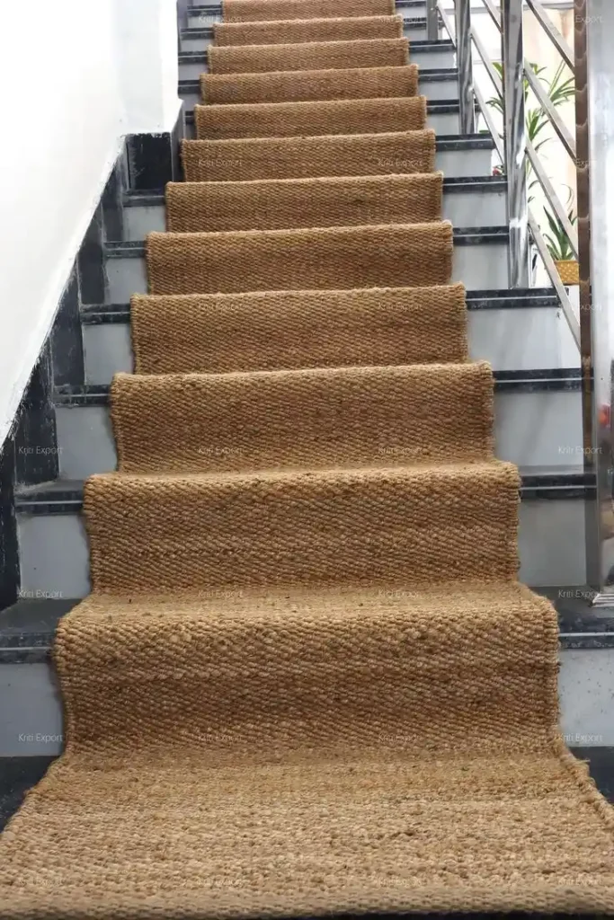 Natural tan hand-woven jute stair carpet runner fitted on marble stairs for Jute Stair Runners Dubai.