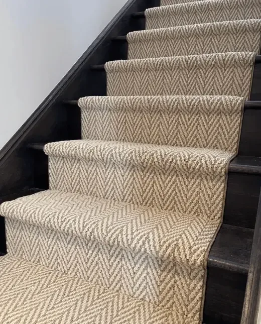 Resilient wool-acrylic blend patterned stair runner fitted on dark wooden steps for Wool-Acrylic Stair Runners Dubai.