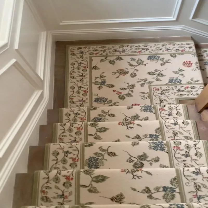 Royal Floral Stair Carpet runner on wooden stairs with a matching landing mat in a cream, green, and blue botanical pattern.